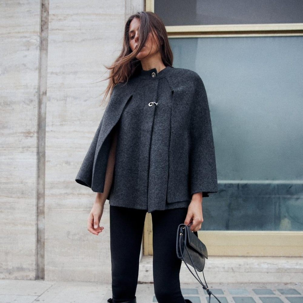 Femme portant cape poncho gris anthracite col montant avec boucle métal, vue de face