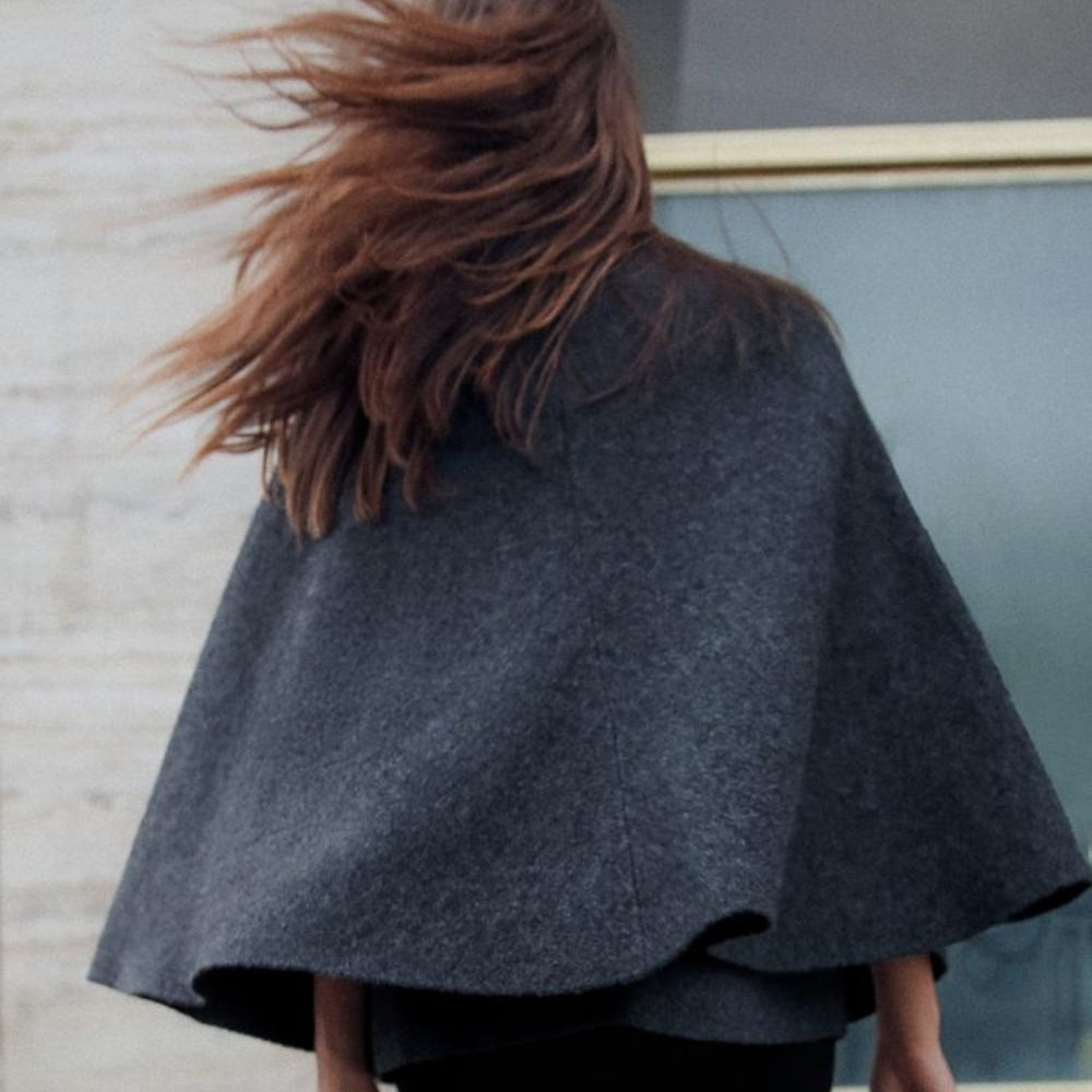 Femme portant cape poncho coton gris anthracite col montant boucle métal, vue de dos
