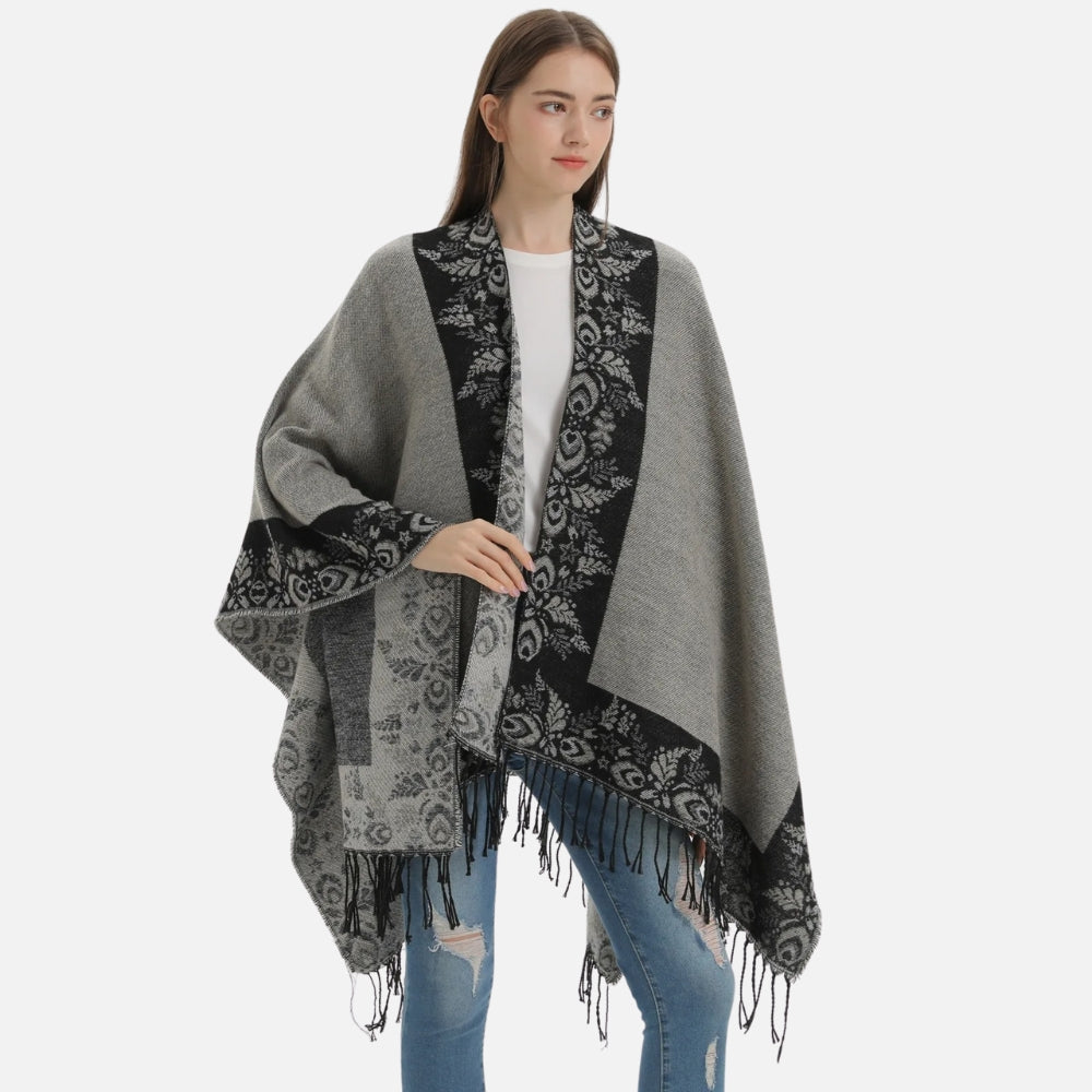 Cape poncho femme grise avec motifs floraux noirs et franges, portée de face