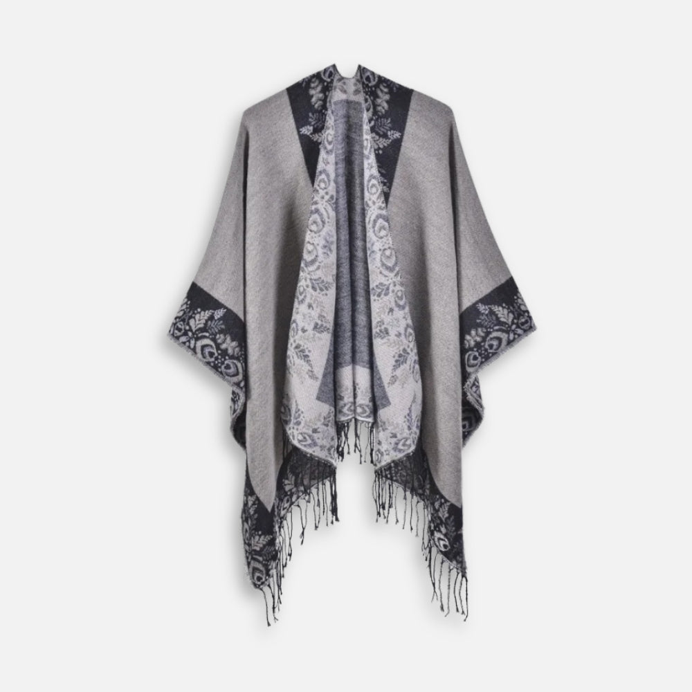 Cape poncho femme grise avec motifs floraux noirs, franges et détails en dentelle