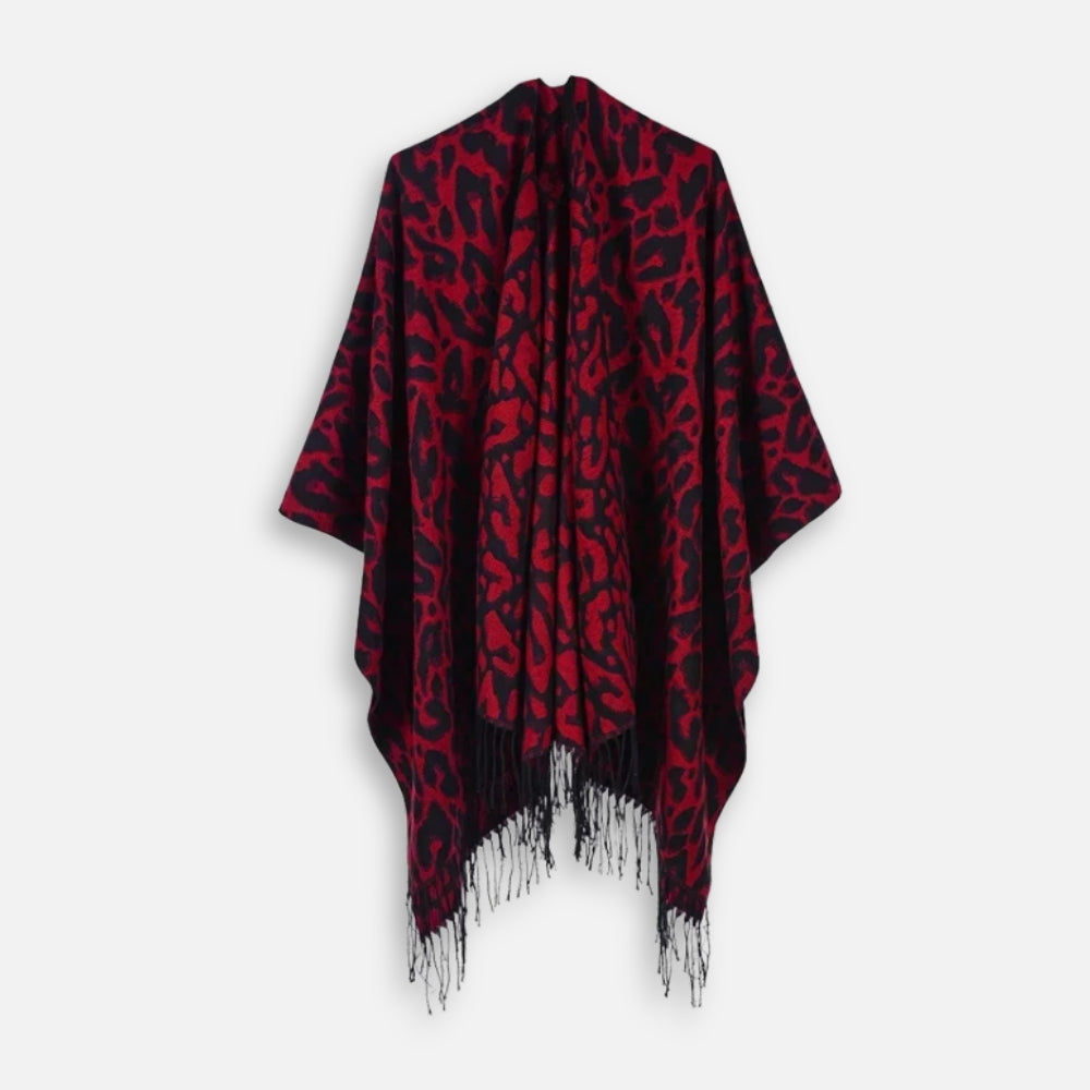 Cape poncho femme imprimé léopard rouge bordeaux avec franges blanches présentée à plat