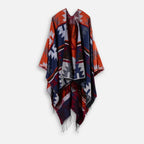 Cape poncho femme péruvienne orange bleu motifs géométriques franges, vue de face suspendue