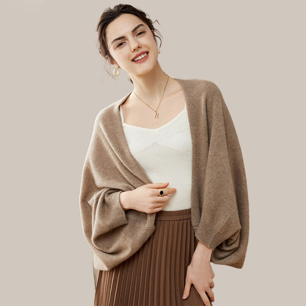 Cape poncho laine femme beige clair, bords côtelés, portée de face avec top blanc crème