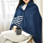 Femme portant une cape poncho polaire marine avec col montant, boutons pression et rayures blanches