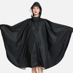Femme portant poncho pluie noir polyester avec capuche et boutons pression vue de face